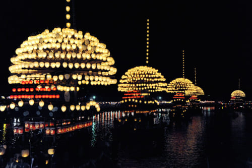 宵宮では、山型に飾られた提灯をのせた５艘のまきわら船が天王川を渡る。